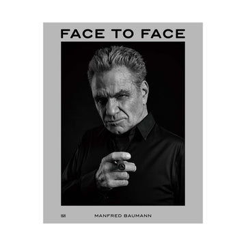 Book cover of 'Face to Face' by Manfred Baumann with a black and white portrait of a man.